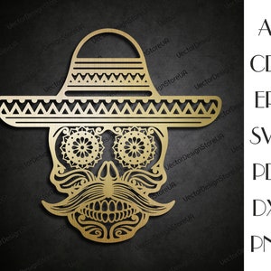 May include: A gold-colored, decorative, laser-cut design of a skull wearing a sombrero. The skull has intricate details, including a mustache, eyes, and teeth. The sombrero has a wide brim and a decorative pattern.