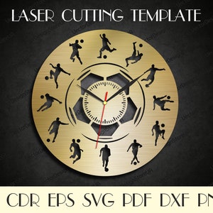 May include: A gold-colored laser cut template of a clock with a soccer ball design. The clock face features a soccer ball with 12 soccer players in various poses around the clock face. The template is labeled "LASER CUTTING TEMPLATE" and includes the file formats AI, CDR, EPS, SVG, PDF, DXF, and PNG.