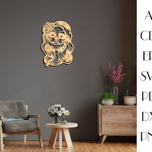 May include: A wooden cutout of a woman's face with a flower in her hair. The woman has a sugar skull design on her face. The cutout is a light brown colour.