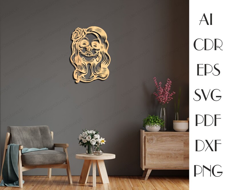 May include: A wooden cutout of a woman's face with a flower in her hair. The woman has a sugar skull design on her face. The cutout is a light brown colour.