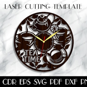 May include: A brown wooden clock with a teacup, teapot, and leaves design. The clock face has a gold clock hand and a red clock hand. The clock face says "Tea Time".