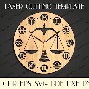 May include: A laser cut wooden clock face with a zodiac theme. The clock face features the scales of Libra, the zodiac sign for Libra, and the symbols for all 12 zodiac signs. The clock face is brown and has a wood grain texture. The clock hands are black and red.