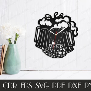 May include: Black and white clock with a beer mug design. The clock face has a black background with white numbers and hands. The beer mug is filled with foam and has the word "BEER" written on it.
