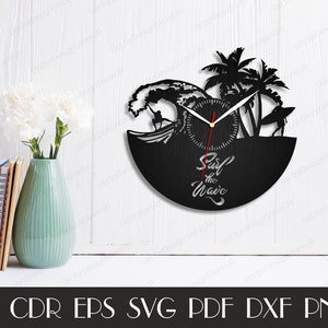 May include: Black and white vinyl record clock with a surfer riding a wave and palm trees. The clock face says "Surf the Wave".