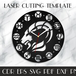 May include: A black and white laser cut clock design featuring the zodiac signs and a Capricorn symbol. The clock is round and has a wood grain texture. The text "LASER CUTTING TEMPLATE" is at the top of the image. The text "AI CDR EPS SVG PDF DXF PNG" is at the bottom of the image.