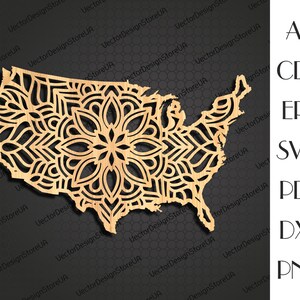 May include: A laser cut wooden outline of the United States with a mandala design inside. The mandala is intricate and detailed, with a variety of shapes and patterns.