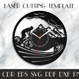 May include: Black and white laser cut design of a mountain biker riding through a mountain landscape. The design includes a clock face with hands. The text "LASER CUTTING TEMPLATE" is at the top of the design.