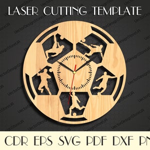 May include: A laser cut wooden clock design featuring a soccer ball with five players in different positions. The clock face is in the center of the soccer ball.