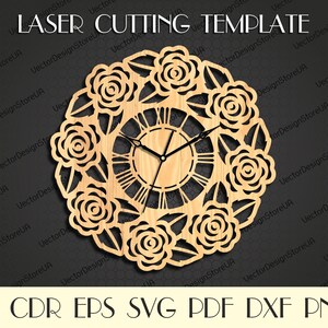 May include: A laser cut template design for a clock with a floral motif. The clock face features Roman numerals and a detailed design of roses and leaves.