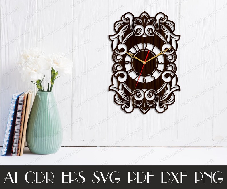 May include: A decorative wooden wall clock with an ornate, scrollwork design. The clock face is dark brown with gold hands and a red second hand. The clock is rectangular with a detailed border. The image also shows a vase with flowers and books.