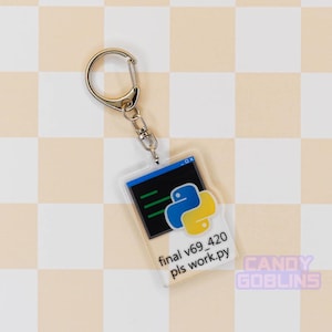Our Python keychain is laid out against a pastel yellow backdrop. It features the Python logo, with text underneath that reads "final v69_420 pls work.py".