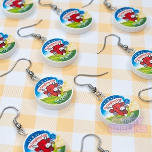 Many Laughing Cow earrings laid out