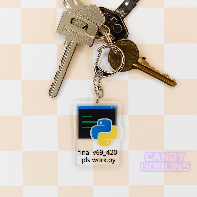 Our Python keychain is attached to a set of keys that is laid out against a pastel yellow backdrop. The keychain features the Python logo, with text underneath that reads "final v69_420 pls work.py".