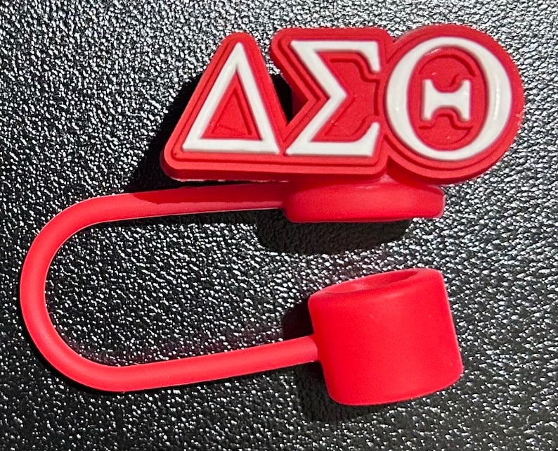 May include: Red silicone bottle stopper with a white and red Delta Sigma Theta sorority logo.