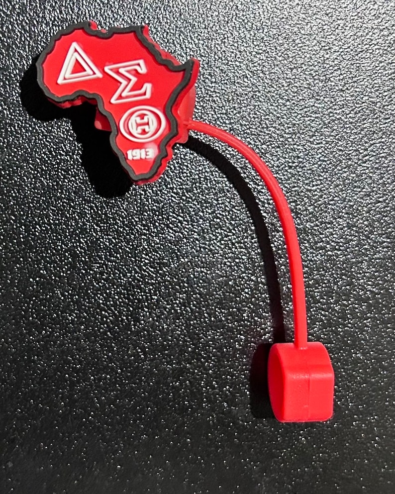 May include: Red silicone keychain shaped like the continent of Africa with the letters "&Delta;&Sigma;&Theta;" and the year "1913" printed on it.