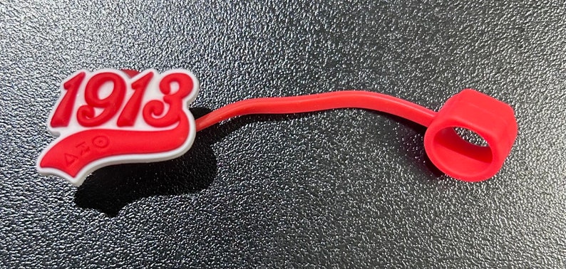 May include: Red rubber cable tie with a red and white 1913 logo. The logo is in a white and red baseball style font.