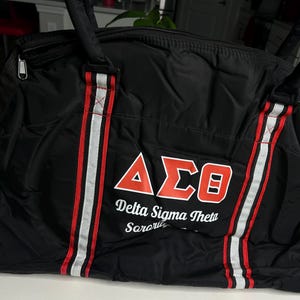 Black and red DST travel duffle bag