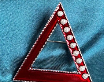 Red and silver broach with 9 pearls