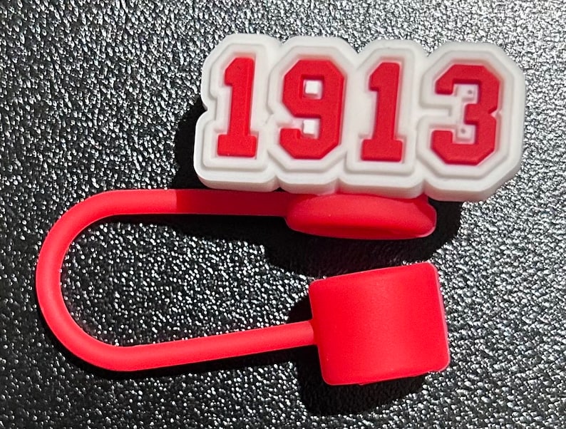 May include: Red and white silicone bottle stopper with the number 1913 printed on it.