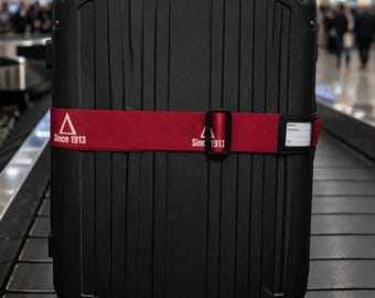 Karmozijnrode en crèmekleurige bagageriem