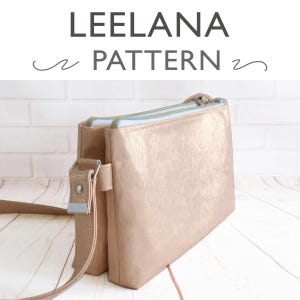 May include: A light brown crossbody bag with a textured finish. The bag features a long strap, a silver buckle, and a zip closure. The text "LEELANA PATTERN" is visible at the top of the image.
