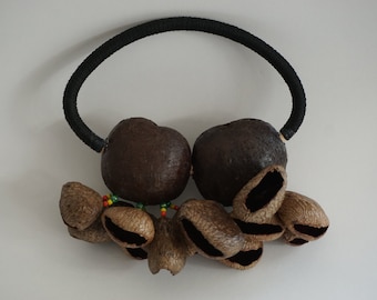 A Hand-held Shaker made of Tree Nut Shells - Handicraft