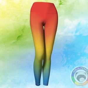Image of a pair of Ninja Ferret Art pride yoga leggings against a green and blue  pastel background. They have a rainbow colour gradient from red at the top through blue at the ankles.