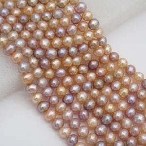 May include: A strand of multi-colored freshwater pearls. The pearls are a mix of light pink, lavender, and cream colors. The pearls are round and have a smooth, lustrous finish.