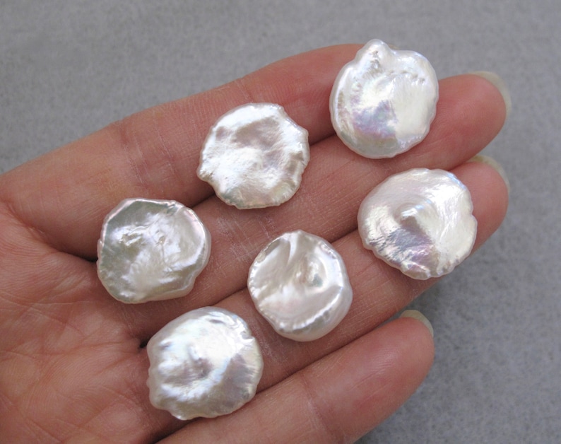 May include: Six white, round, irregular shaped freshwater pearls with iridescent sheen.