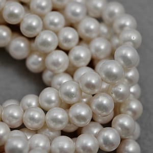 10.3-11.3mm White Freshwater Pearl Beads: AA+ Semi Round Strand