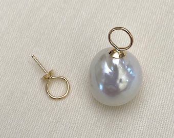 May include: A white pearl with a gold loop attached to the top. The pearl is about 1 inch in diameter. There is also a gold earring post with a loop on the side.