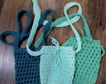 May include: Three crocheted bags in teal, light green, and dark green. The bags are made with a simple stitch and have a drawstring closure.