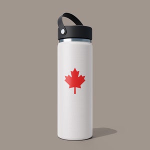 May include: White water bottle with a black lid and a red maple leaf design.