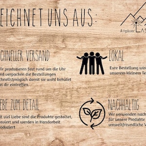 May include: A wooden sign with text in German, including "DAS ZEICHNET UNS AUS:" and other phrases. The sign also features several black line drawings of a box, people, a heart, and a recycling symbol. The sign is from Allg&auml;uer Laserschmiede.