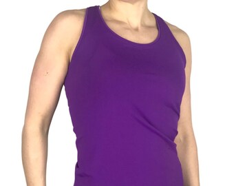 May include: A vibrant purple athletic tank top with a racerback design. The tank top is paired with a black athletic skirt. The outfit is suitable for various fitness activities.
