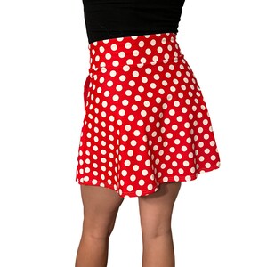 May include: A red and white polka dot skirt with a high waist and a flared silhouette.