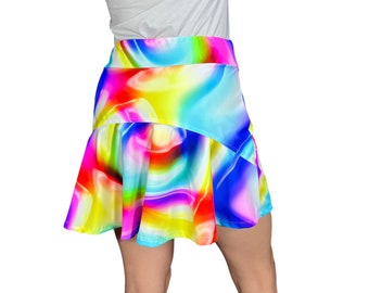 May include: A colorful, abstract print skirt with a flowing, A-line silhouette. The skirt features a vibrant mix of pink, blue, yellow, and red hues.