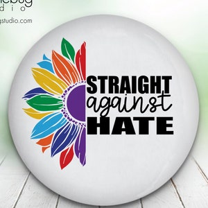 May include: A white button with a rainbow sunflower on the left side and the text "STRAIGHT against HATE" in black on the right side.