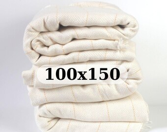May include: A stack of four white fabric panels with thin gold stripes. The panels are folded and the top panel has the text "100x150" printed on it.