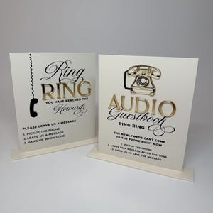 Puede incluir: Dos letreros de boda color crema con letras y detalles dorados. Un letrero dice "Ring Ring" con instrucciones para dejar un mensaje. El otro dice "Audio Guestbook" con instrucciones. Ambos letreros tienen un gr&aacute;fico de tel&eacute;fono.