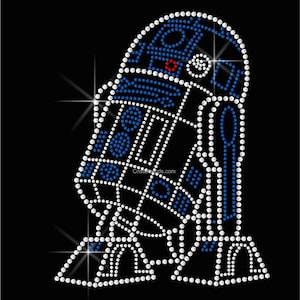 May include: A blue and white rhinestone design of a robot character. The robot has a round head with a single red rhinestone in the center. The robot is standing with its arms at its sides.