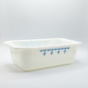May include: White ceramic baking dish with a blue snowflake pattern around the rim.