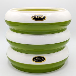 May include: A three-tiered green and white striped candy dish with the words "CANDY" and "NUTS" on the top and bottom tiers.