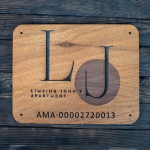 May include: Wooden sign with the letters "LJ" in a circle, the text "Limping John's Apartment" and the code "AMA: 00002720013".