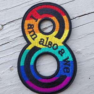 May include: Rainbow-coloured embroidered patch in the shape of the number 8. The text "I am also a wife" is written around the outside of the number.