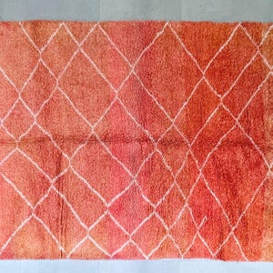 Sunset-inspired wool Berber rug with bold geometric patterns.