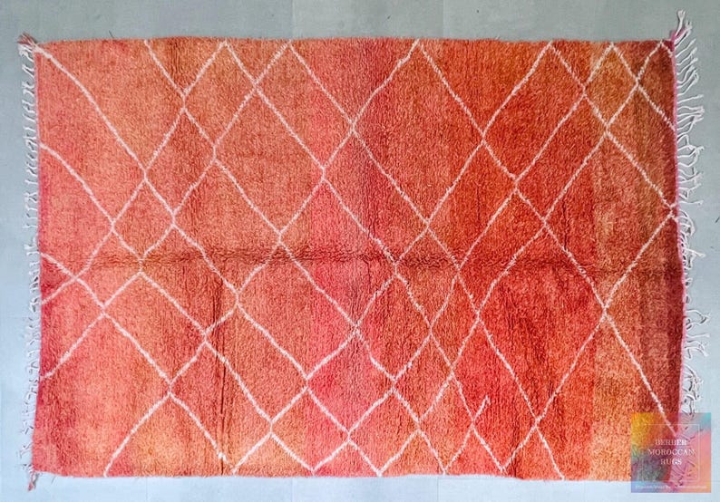 Sunset-inspired wool Berber rug with bold geometric patterns.