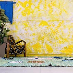 Plush high-pile wool rug featuring vibrant tribal patterns.