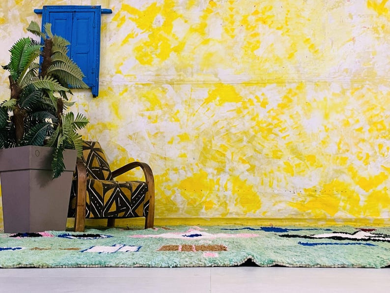 Plush high-pile wool rug featuring vibrant tribal patterns.
