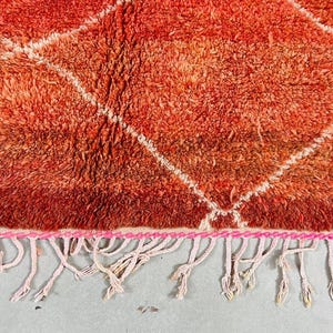 Red and white geometric rug perfect for modern boho decor.